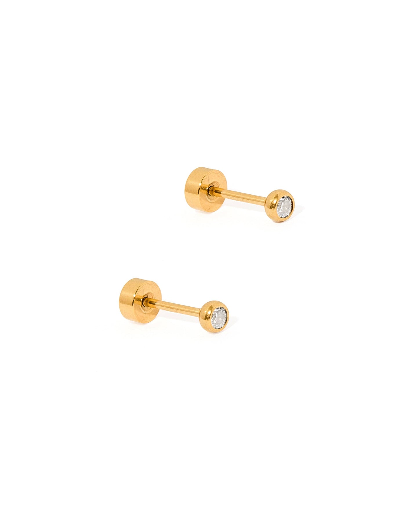 Pair of gold stud earrings with clear gemstones on a white background