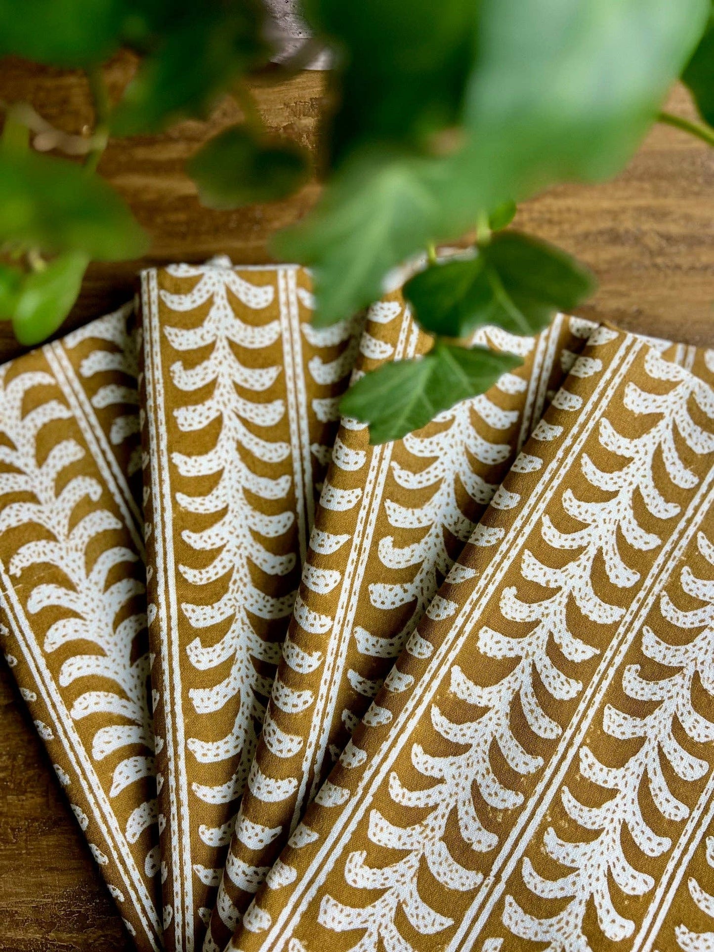 Folded fabric with a leaf pattern on a wooden surface