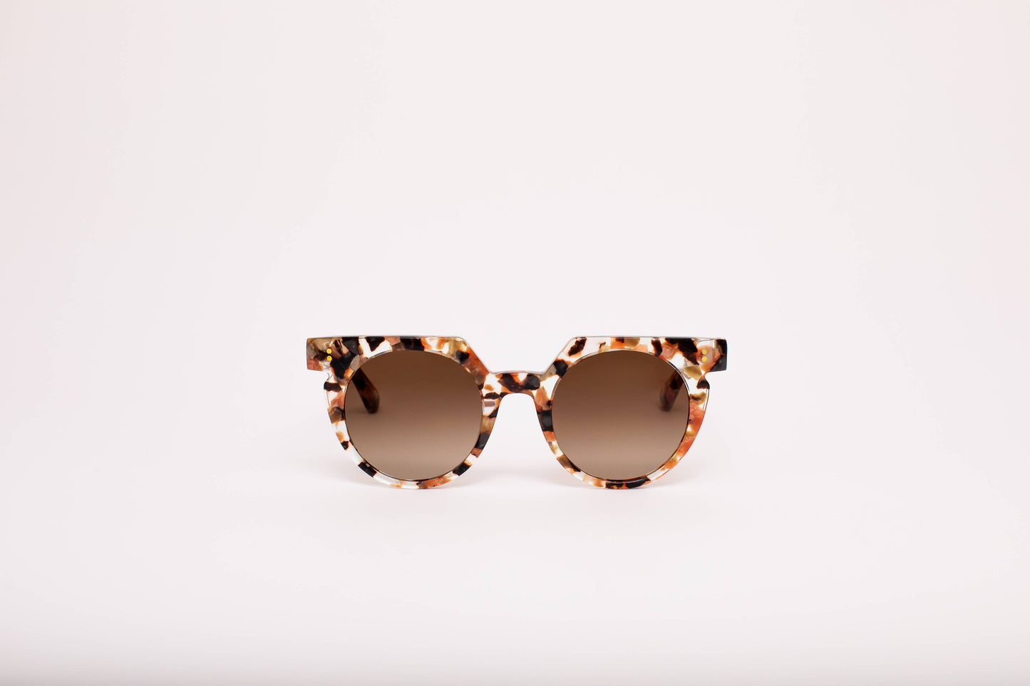 Sunglasses with tortoiseshell frame and brown lenses on a white background