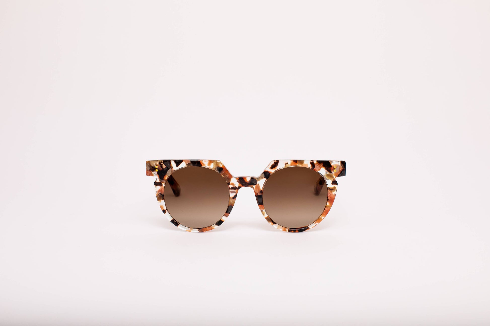 Sunglasses with tortoiseshell frame and brown lenses on a white background