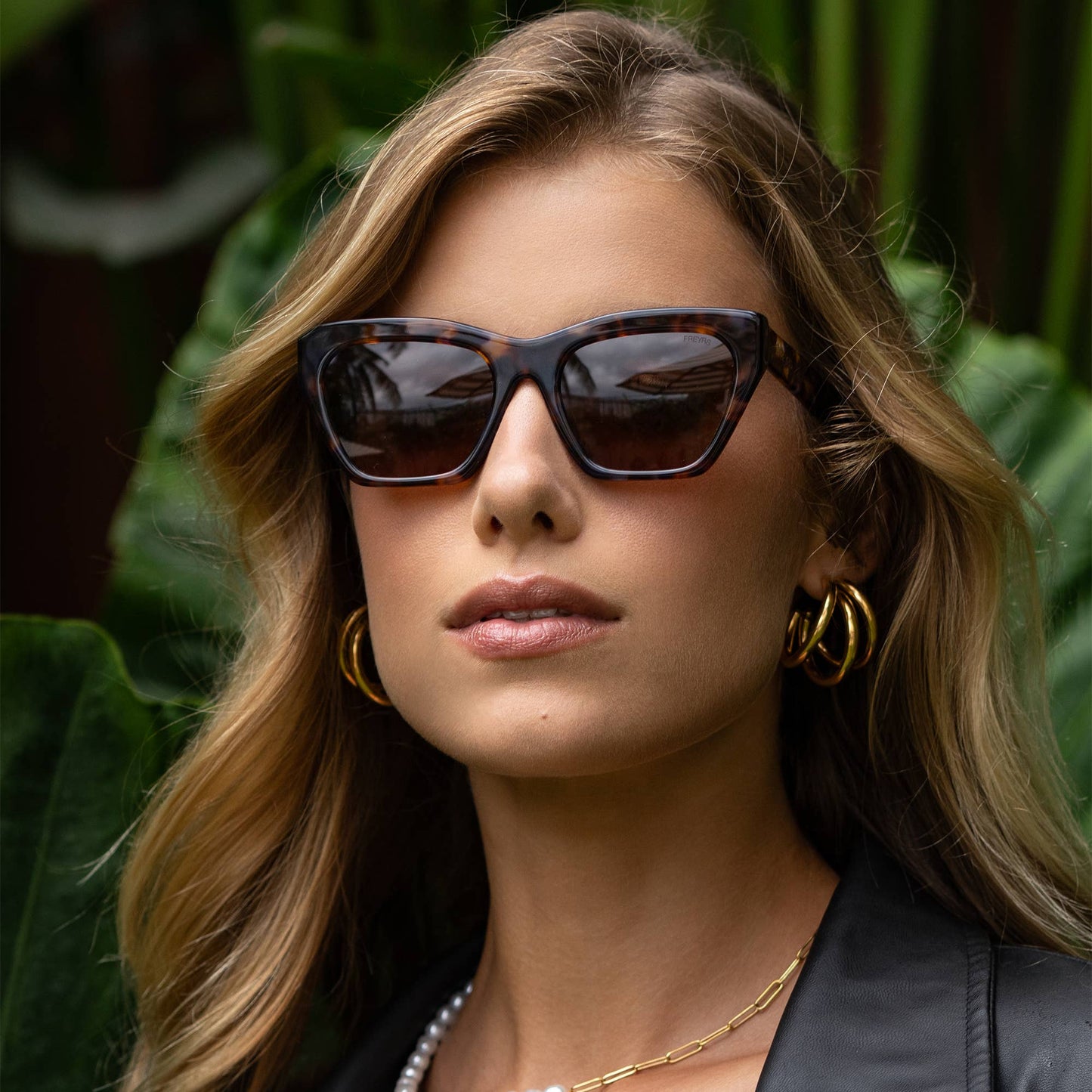 Woman wearing sunglasses with a blurred natural background