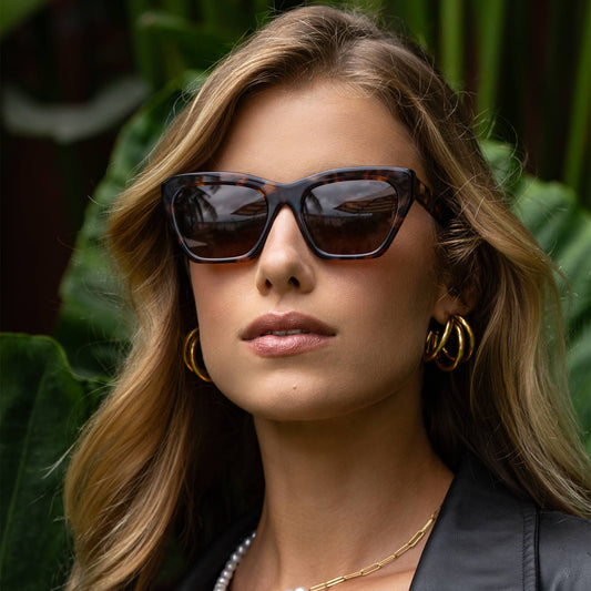 Woman wearing sunglasses with a blurred natural background