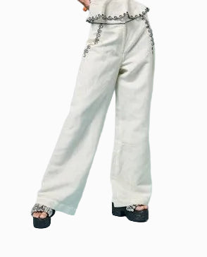 Woman wearing a white top and light blue jeans against a light blue background