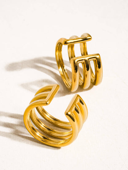 Pair of gold hoop ear cuffs on a white background