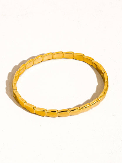 Gold bracelet on a white background