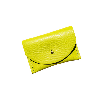 Yellow textured wallet with a black strap on a beige background