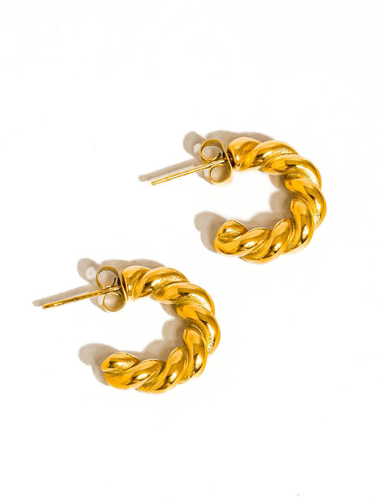 Pair of gold hoop earrings on a white background