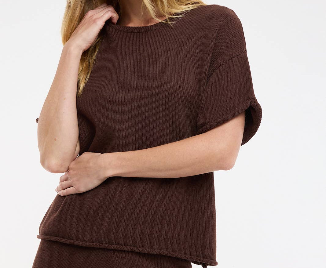 Woman wearing a brown outfit on a white background