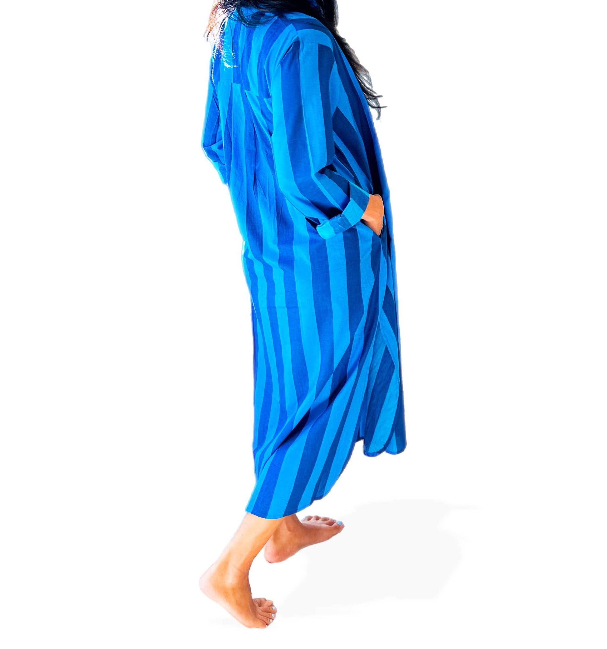 Person wearing a blue striped robe and green cap with 'SUP' on a white background