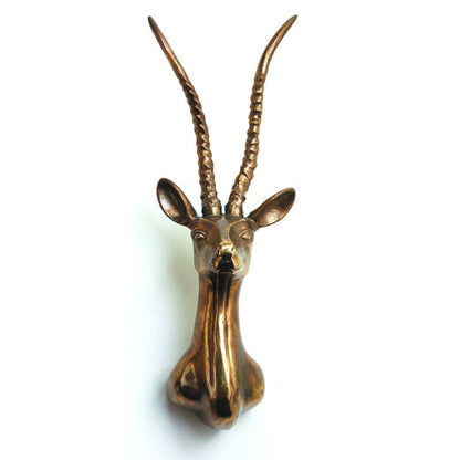 Bronze antelope head sculpture on a white background