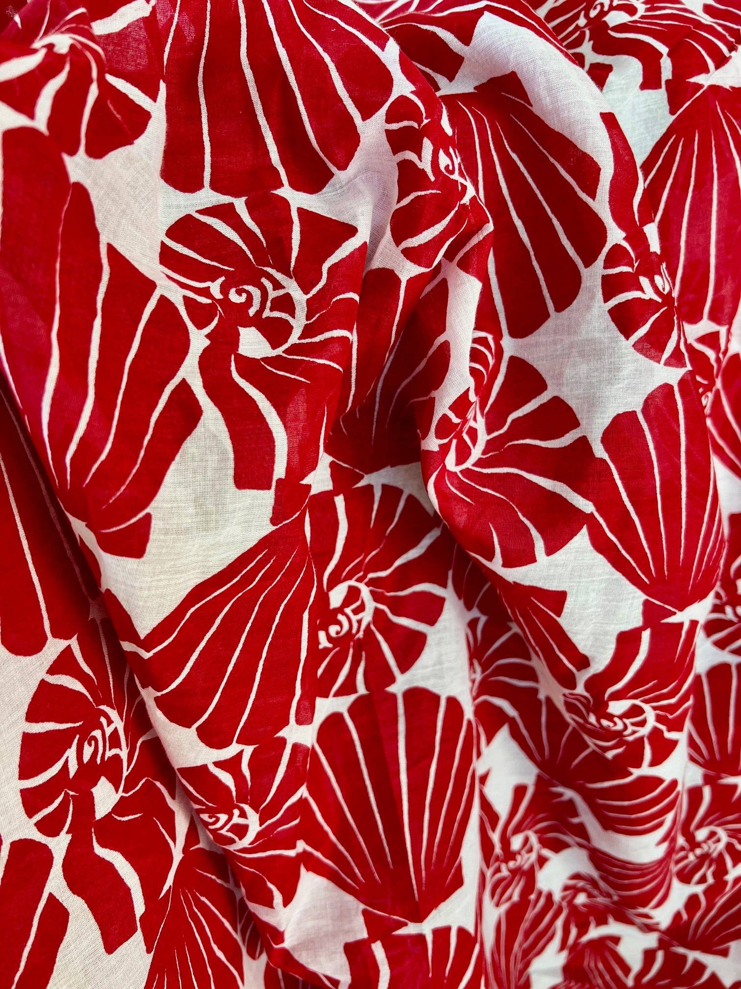 Red floral pattern on white fabric