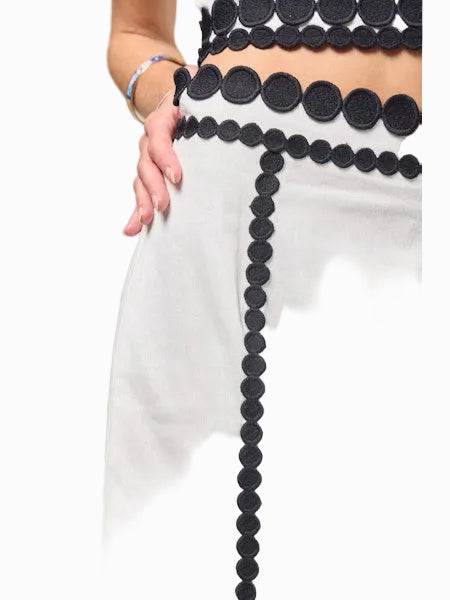 Close-up of a person wearing a black and white outfit with a unique design.