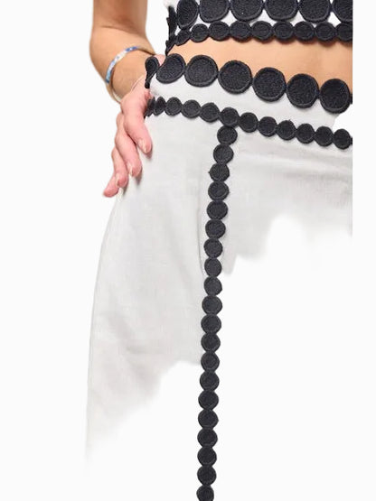 Close-up of a person wearing a black and white outfit with a unique design.