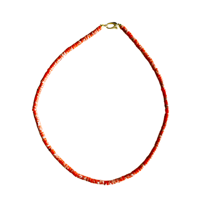 Red beaded necklace on a white background