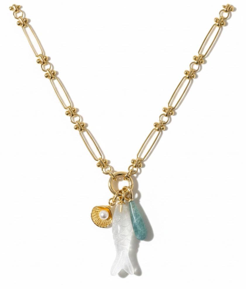 Gold necklace with a white angel pendant and blue gemstone on a white background