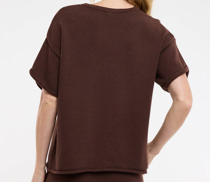 Woman wearing a brown outfit on a white background