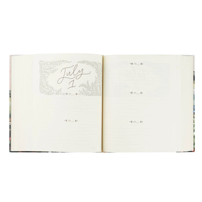 An open monthly devotional showing blank pages with a decorative gray floral border and the cursive date 'July 1' on the left page.