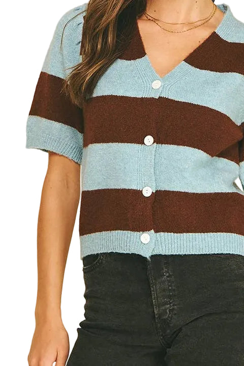 A woman modeling a short-sleeve knit cardigan with horizontal stripes in light blue and dark brown, paired with black denim shorts against a solid white background.
