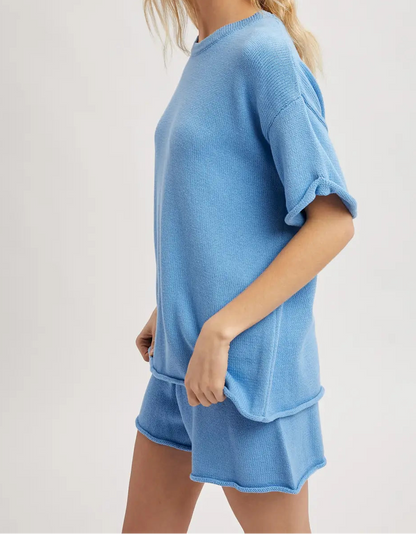 Woman wearing a blue outfit on a plain background