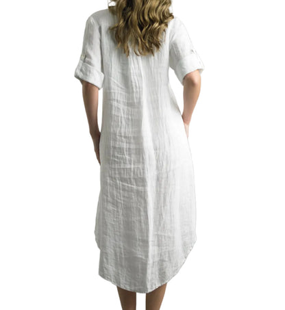Woman wearing a white dress with short sleeves on a gray background