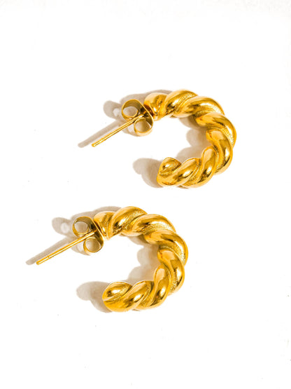 Gold chain hoop earrings on a white background