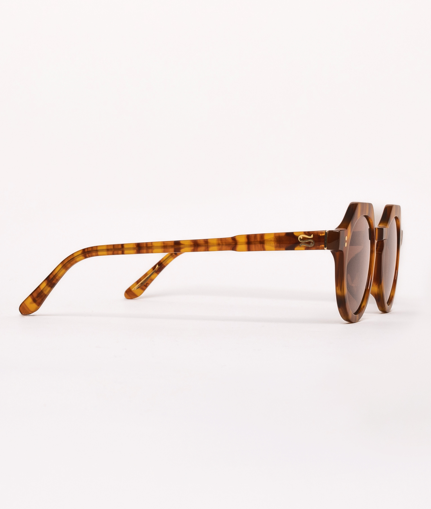 Sunglasses with tortoiseshell frame on a white background