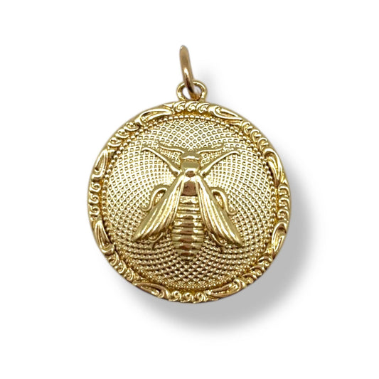 Gold bee pendant on a white background