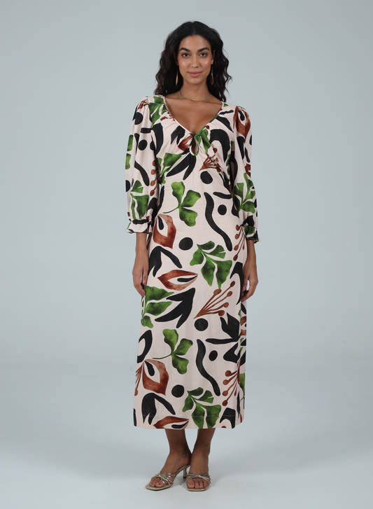 Woman wearing a patterned dress on a plain background