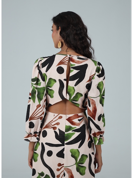 Woman wearing a floral patterned outfit on a plain background