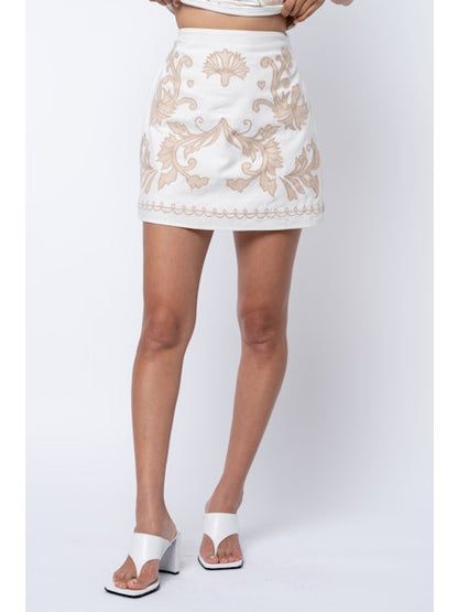 White lace mini skirt worn by a person on a white background