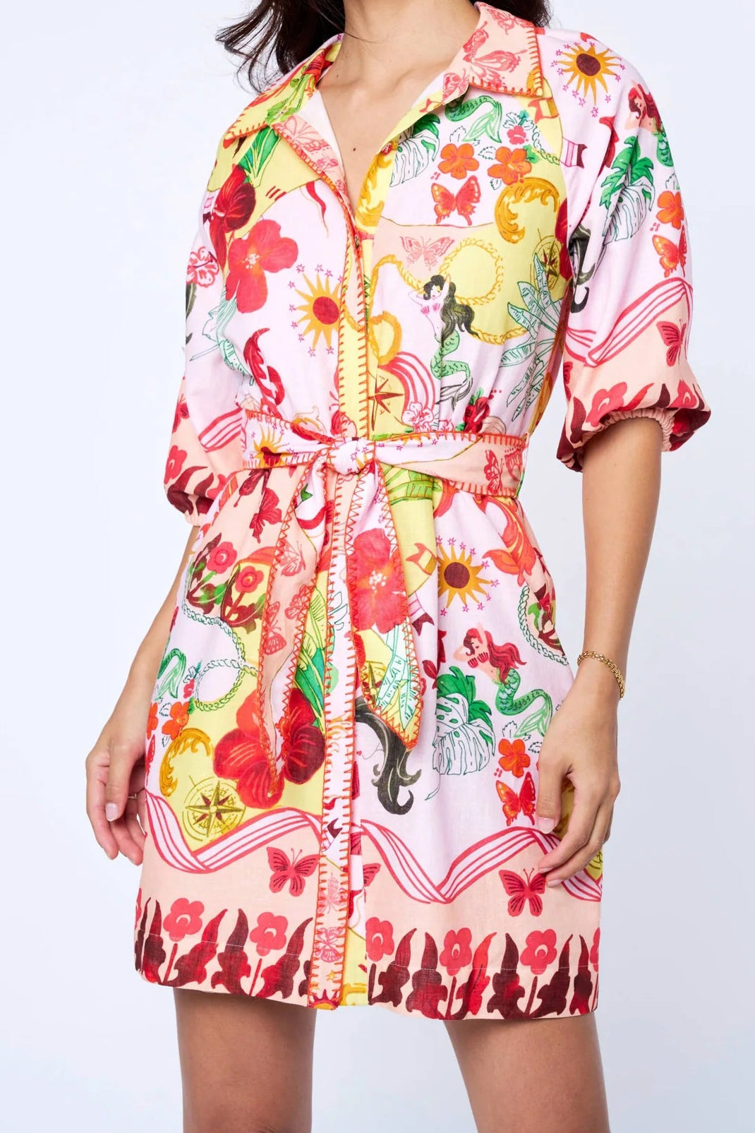 Woman wearing a colorful floral dress on a white background