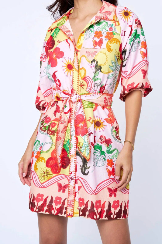 Woman wearing a colorful floral dress on a white background