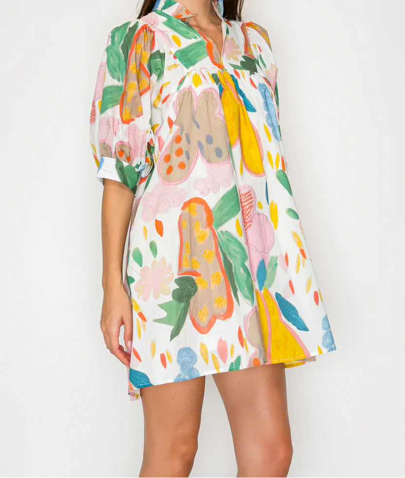 Woman wearing a colorful floral dress on a white background