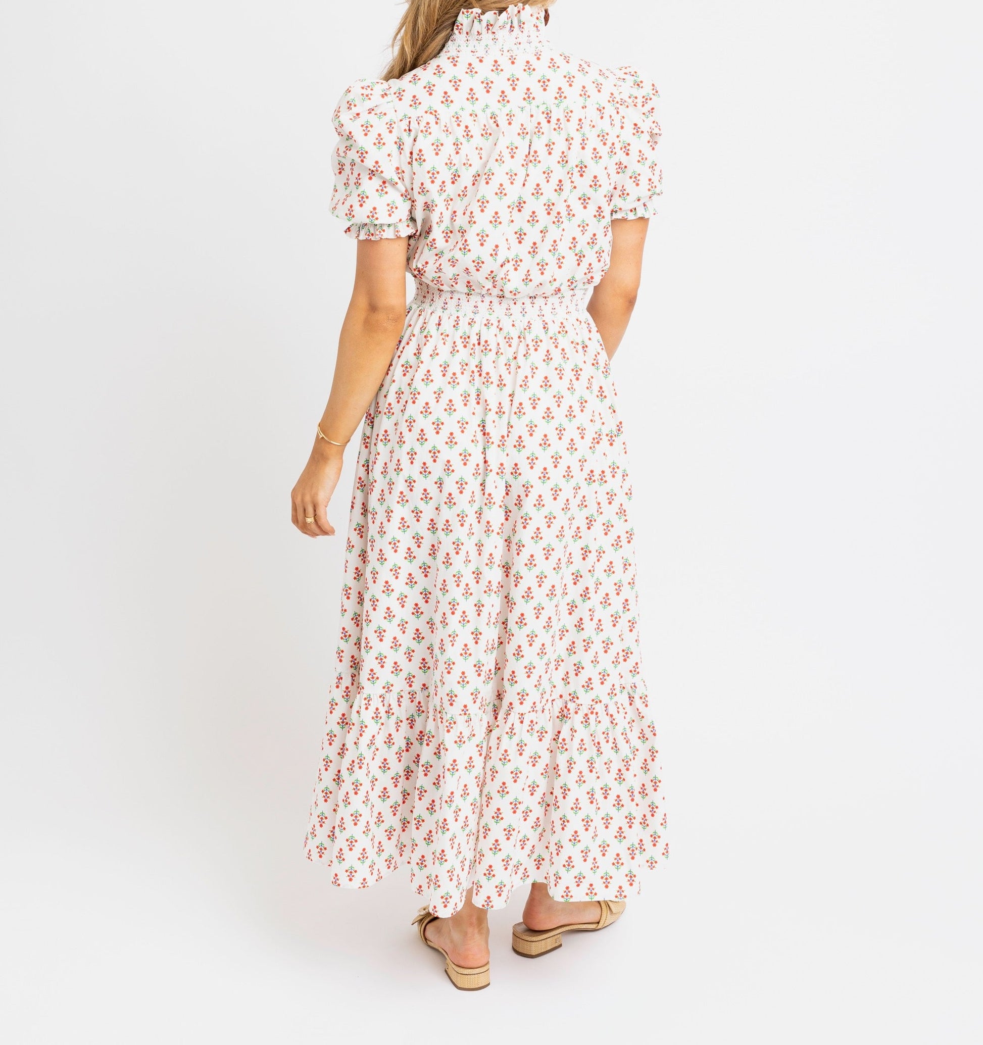 Woman wearing a floral dress on a white background