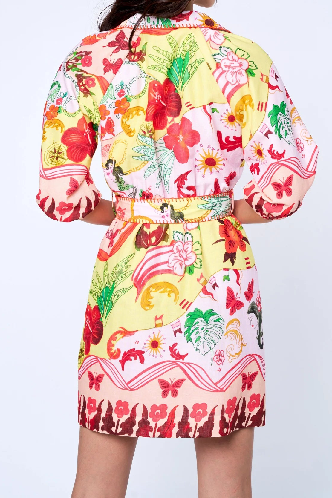 Woman wearing a colorful floral dress with a white background
