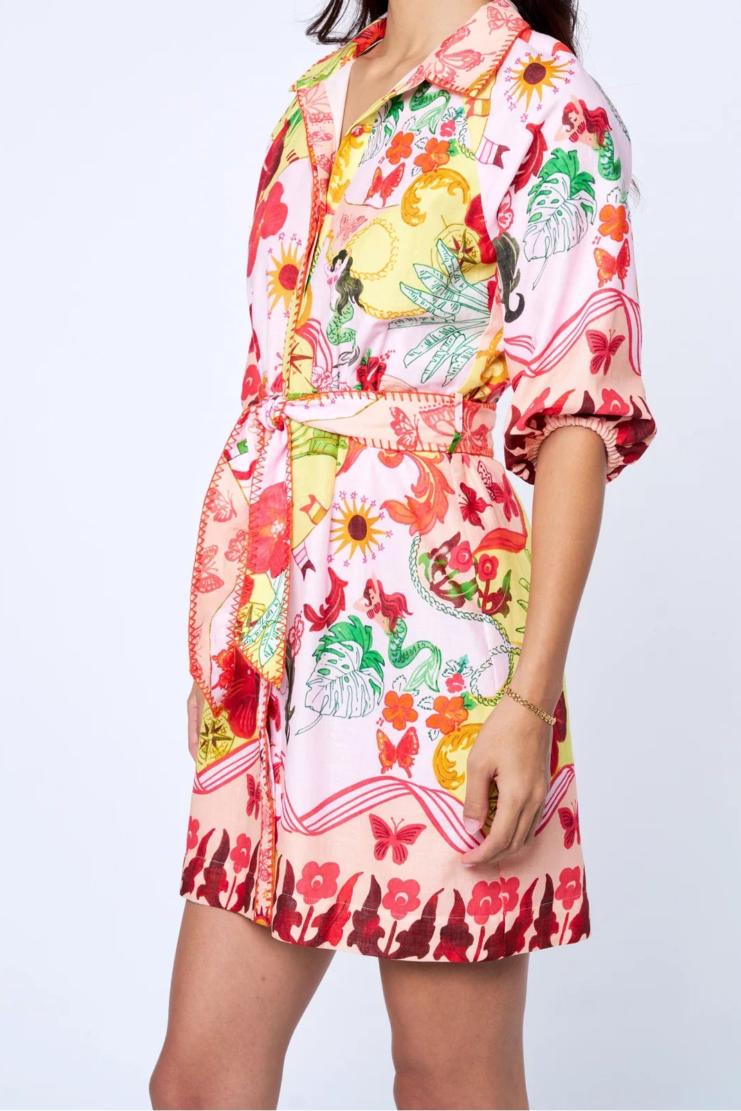 Woman wearing a colorful floral dress on a white background