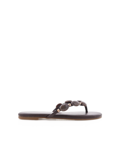Black sandal with decorative straps on a white background