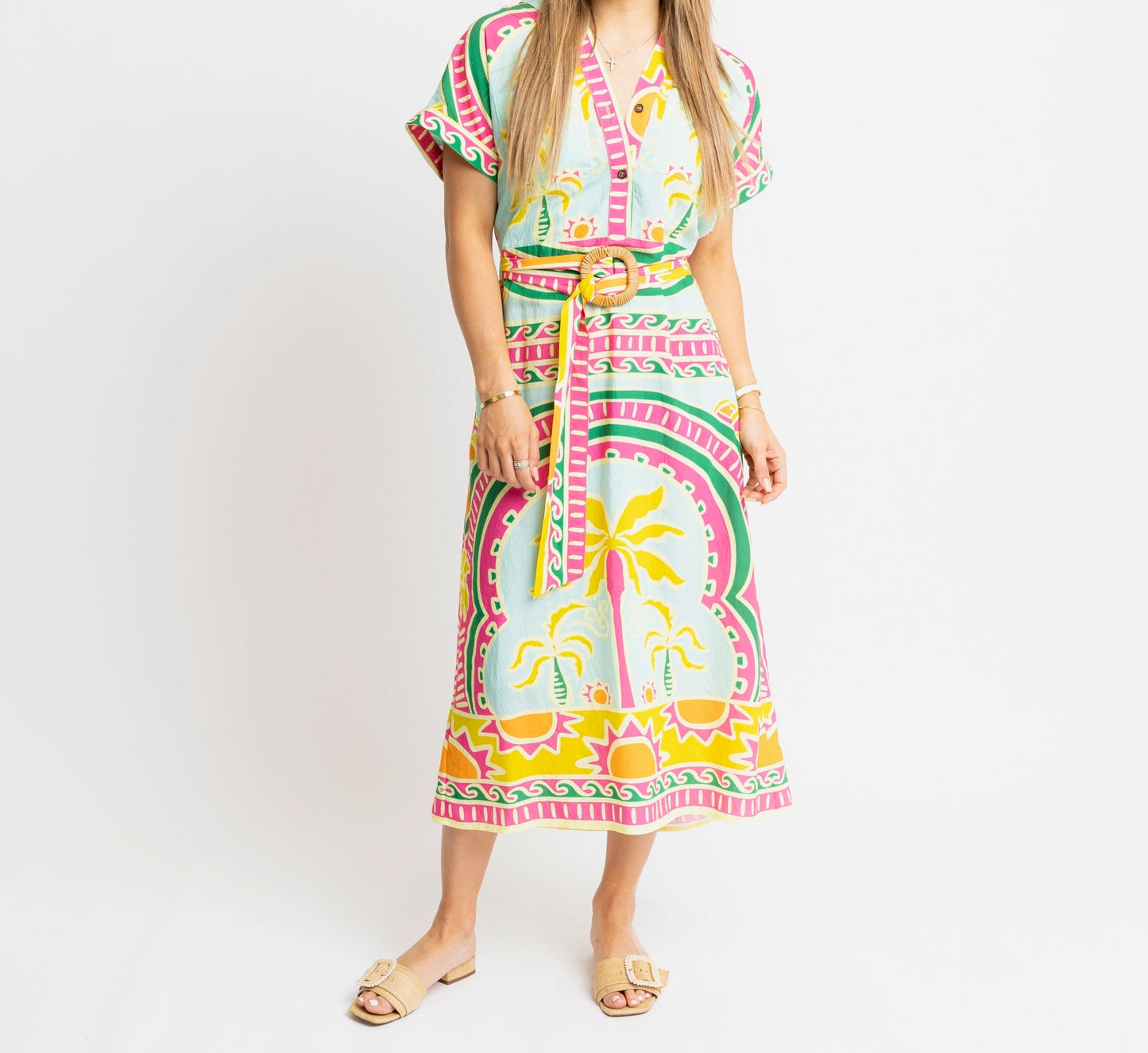 Woman wearing a colorful dress with a pattern on a white background