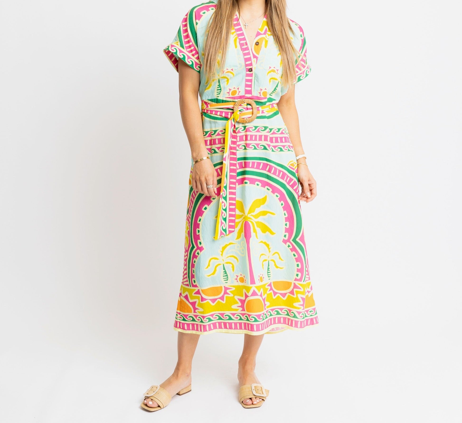 Woman wearing a colorful dress with a pattern on a white background