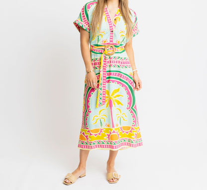 Woman wearing a colorful dress with a pattern on a white background