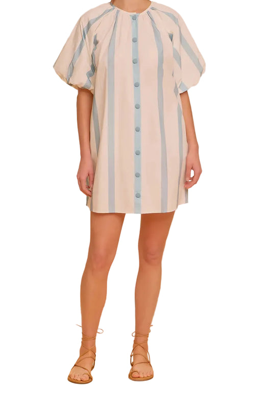 Woman wearing a beige dress with blue stripes on a white background
