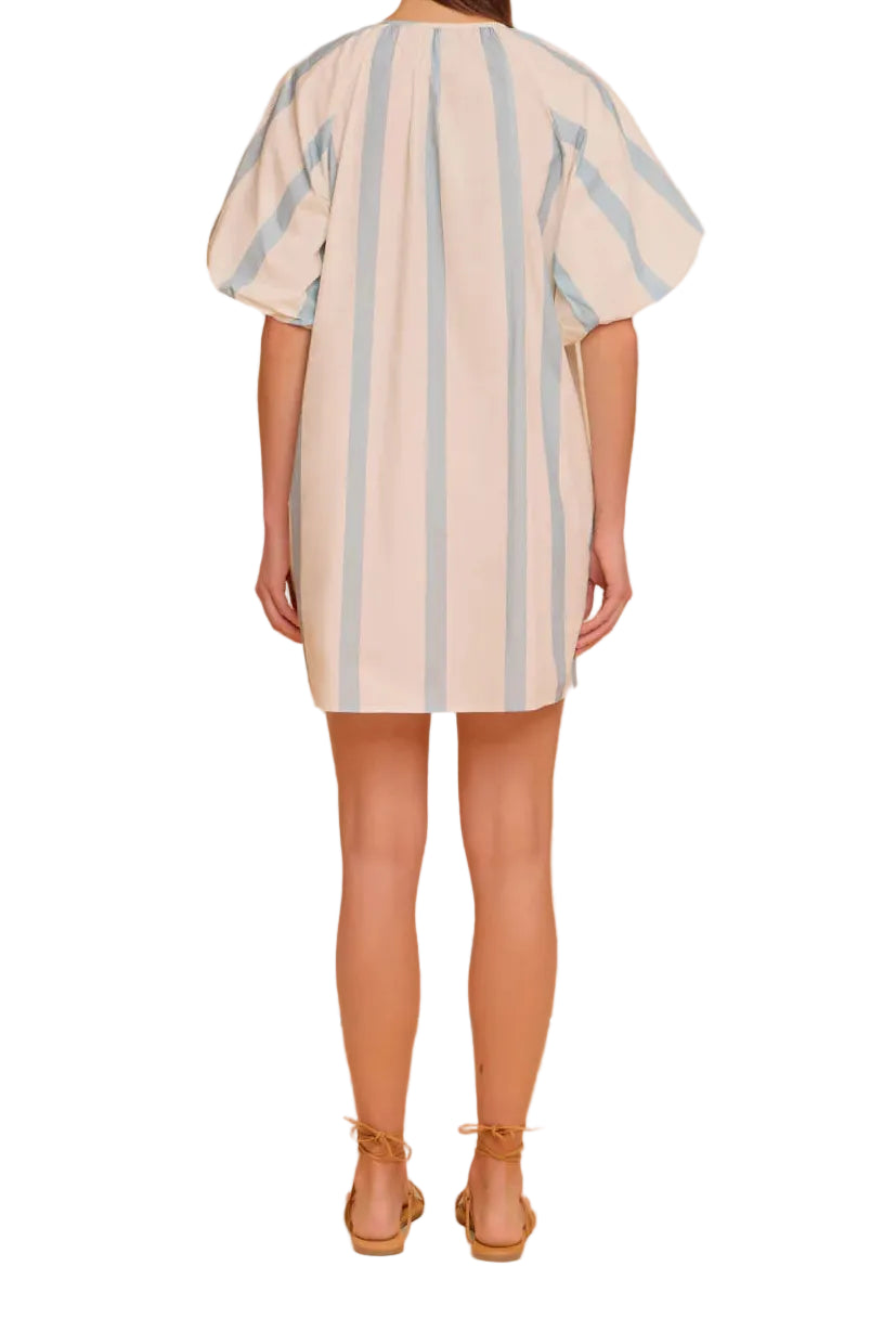 Woman wearing a striped dress against a white background