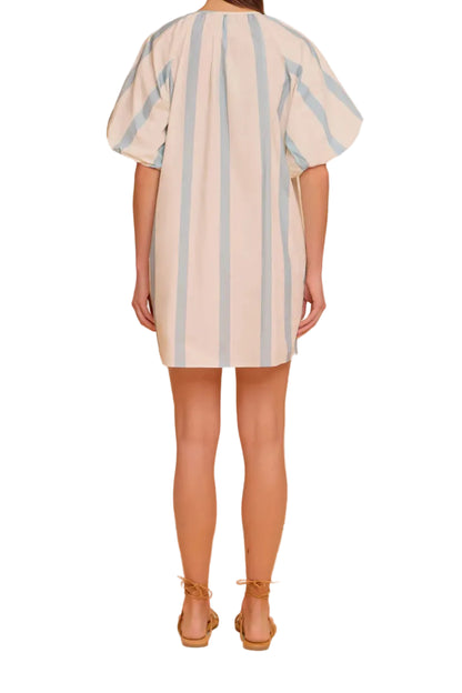 Woman wearing a striped dress against a white background
