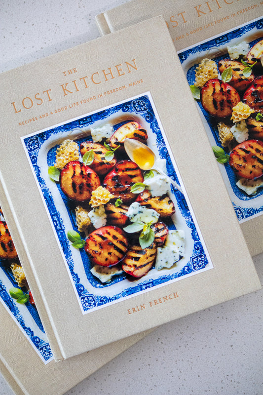 Cookbook titled 'The Lost Kitchen' by Erin French on a light background
