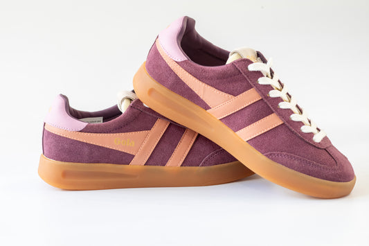 Pair of wine sneakers with Terracotta  accents on a white background