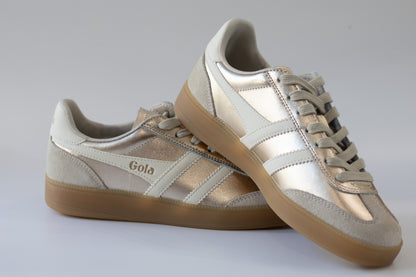 Pair of Gola sneakers with beige and metallic  color scheme on a light gray background