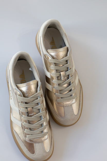 Pair of beige sneakers on a white background