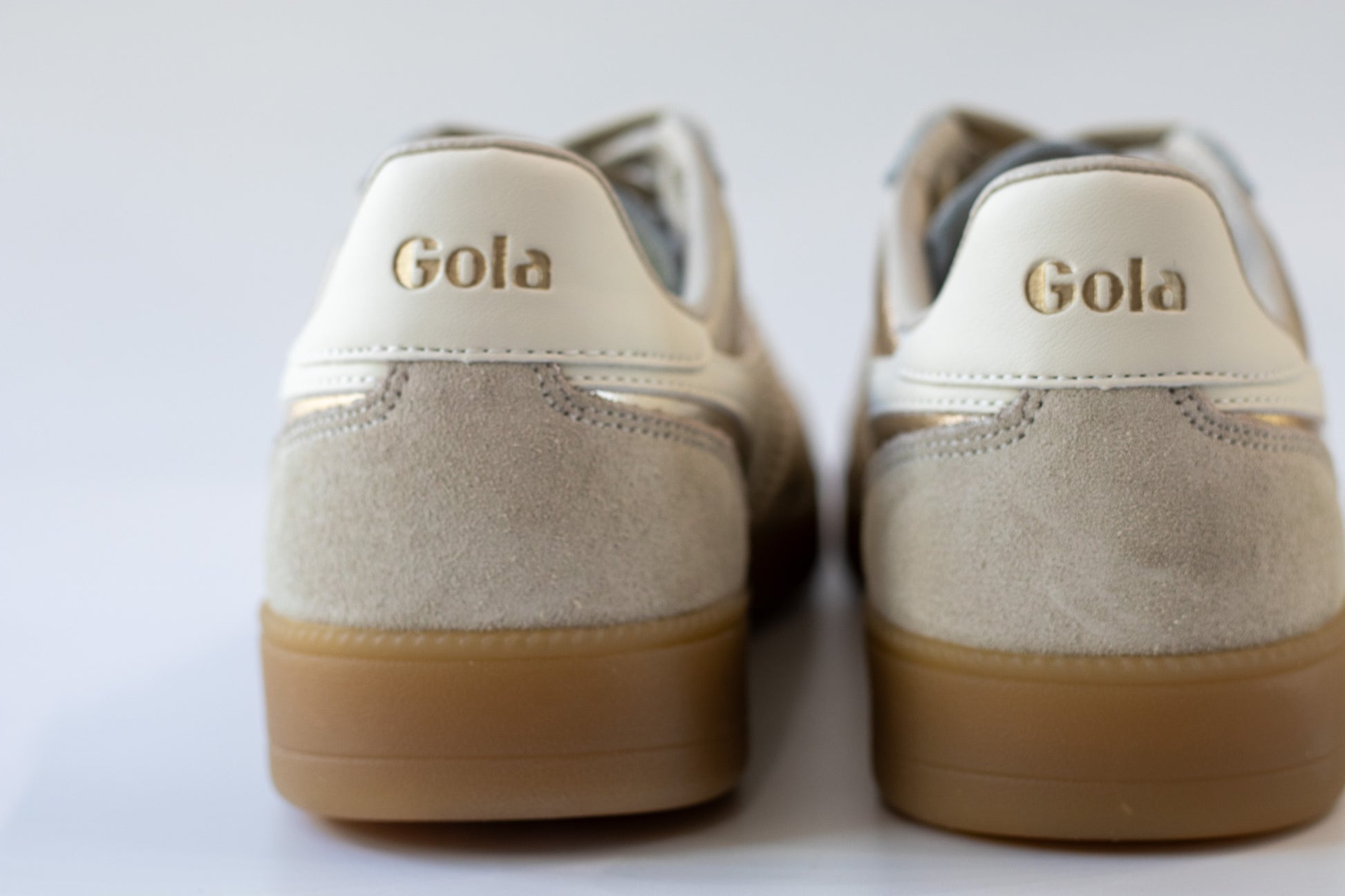 Pair of Gola sneakers with beige soles on a white background
