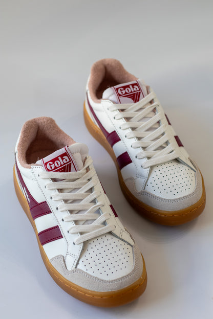 White sneakers with maroon accents and 'Gola' branding on a white background