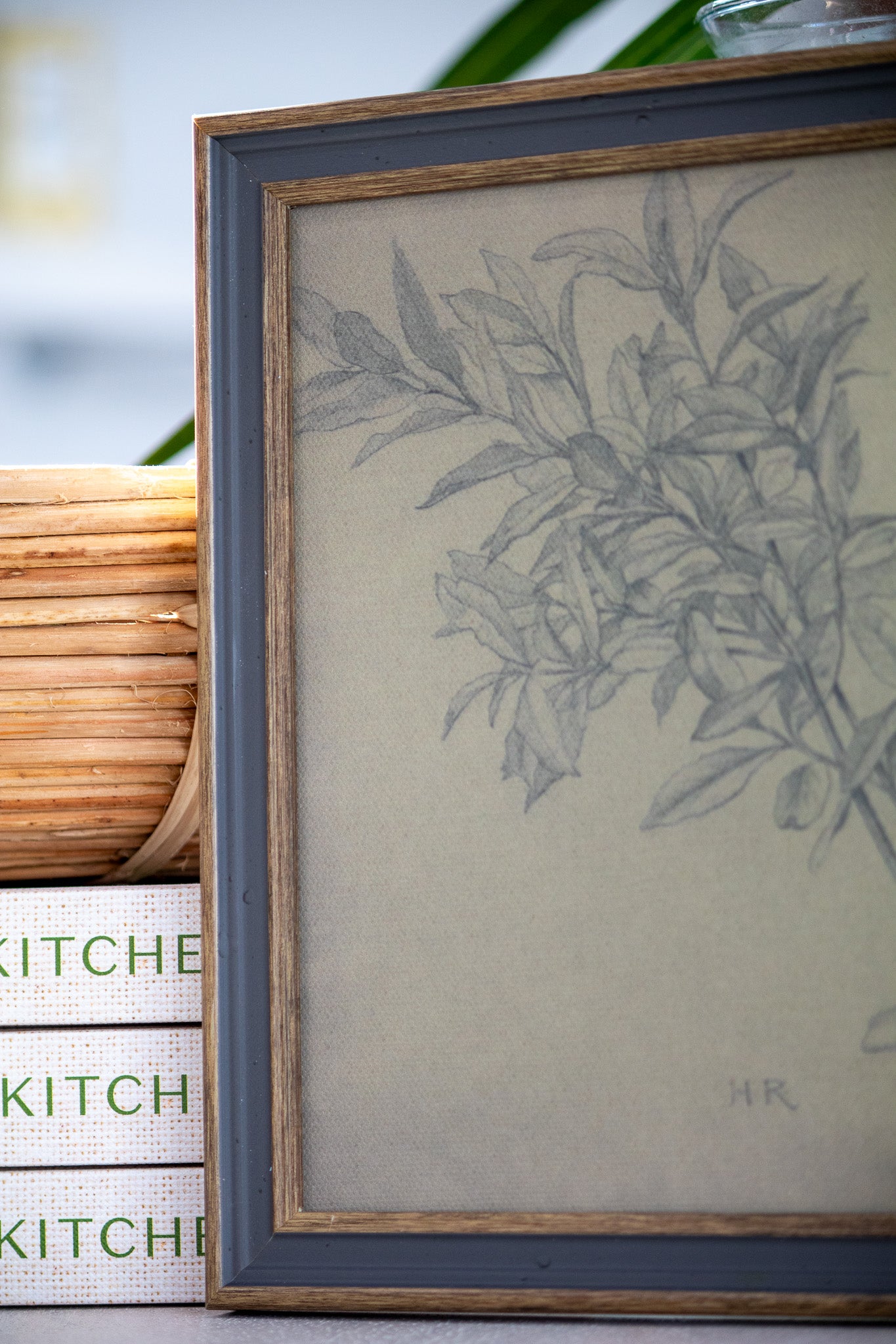 Framed botanical drawing on a kitchen-themed surface
